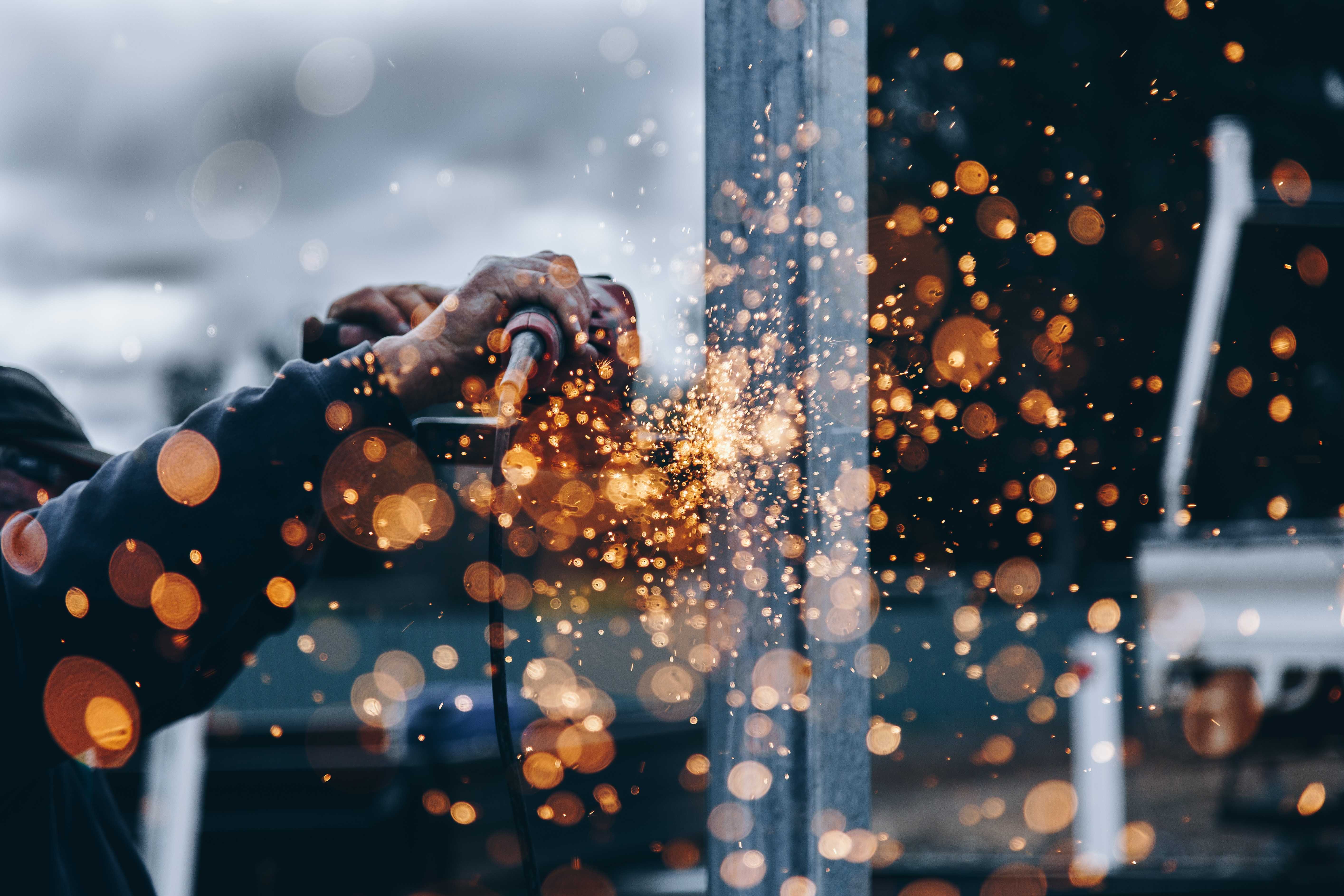 A builder cutting metal on site